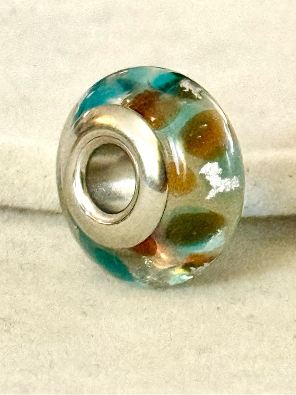 Teal and Brown Murano charm with silver flakes details
